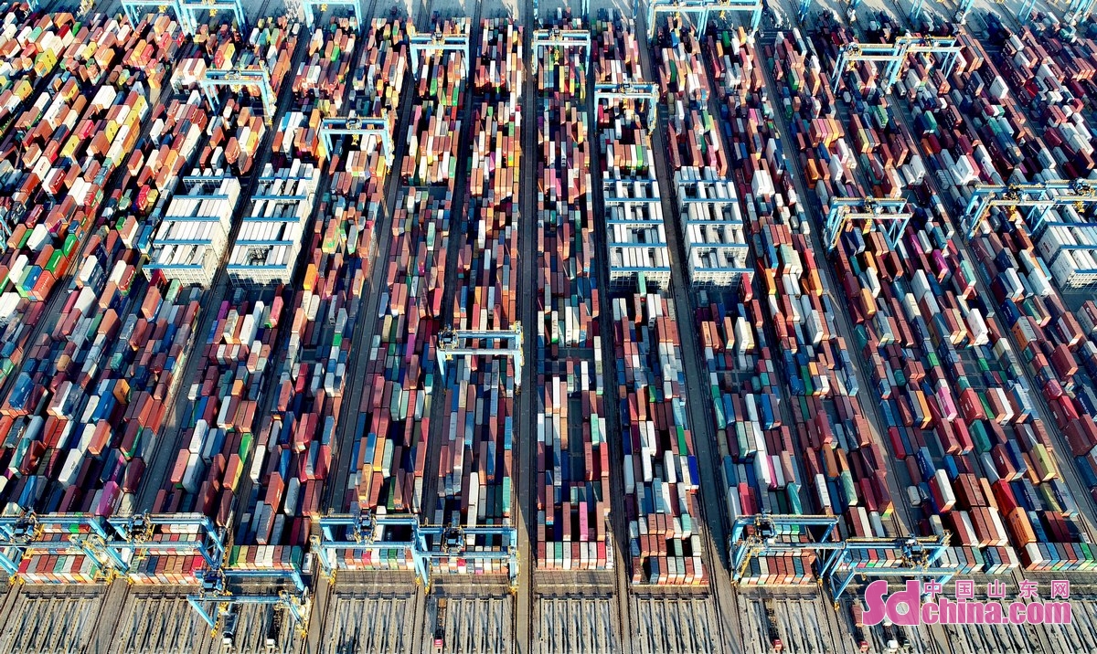 <br/>　　1月14日，在山东港口青岛港全自动化码头集装箱堆场，高速轨道吊来回穿梭运送货物。