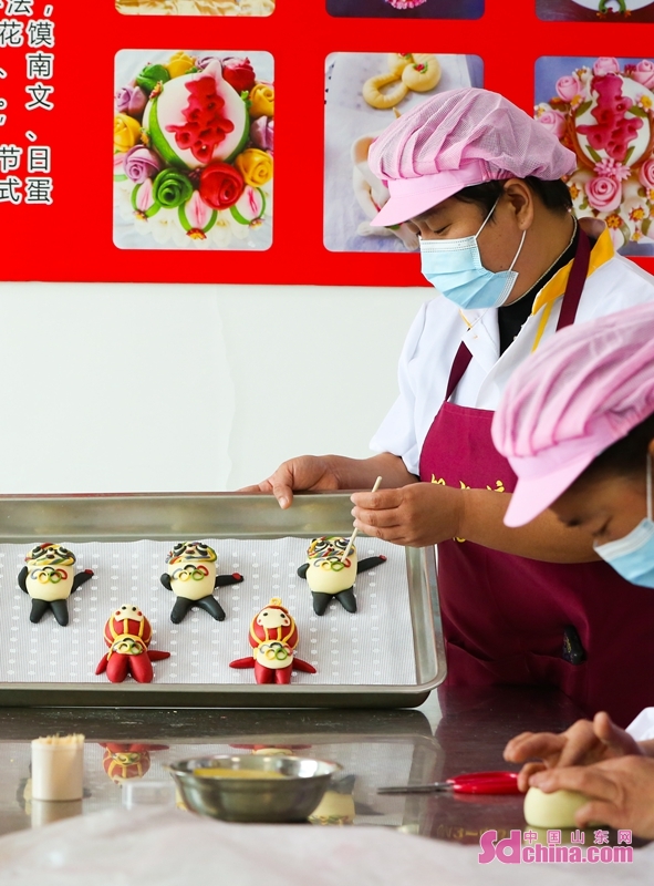 <br/>Pastry chefs are seen making Bing Dwen Dwen-shaped and Shuey Rhon Rhon-shaped steamed buns at a manufacturing workshop in Zouping County-level City, China&rsquo;s Shandong Province.   (Photo by Dong Naide, Huo Guang)<br/>