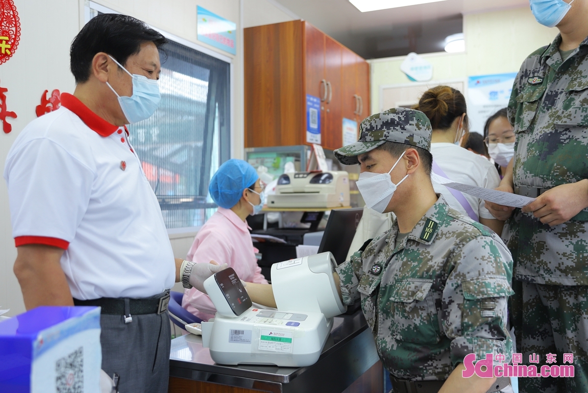 <br/>　　6月14日，在山东青岛李沧区李村献血屋，民兵在测量血压。<br/>