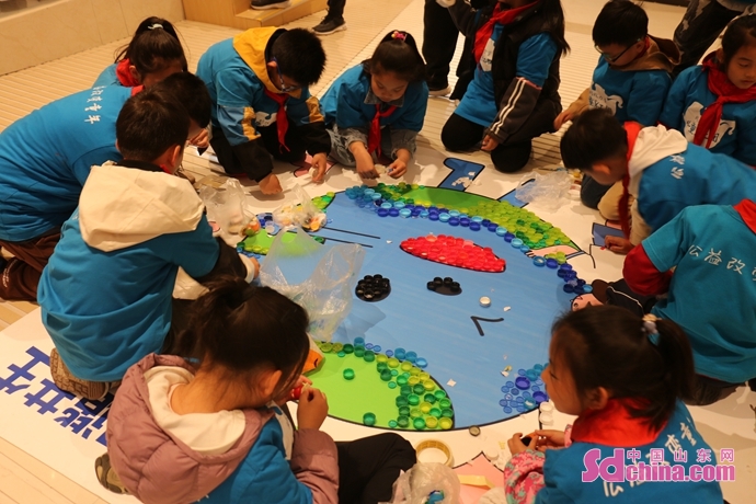 青岛环保小志愿者们用900多个旧瓶盖拼出一幅“地球图”