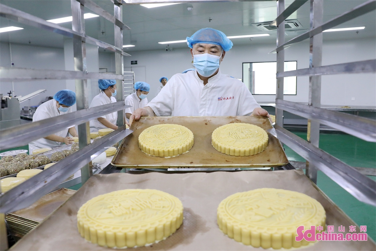 On September 13th, workers are seen stepping up production of large mooncakes to meet the market demand for the upcoming Mid-autumn Festival in a workshop in the Qingdao West Coast New Area, China&rsquo;s Shandong Province.<br/>The &ldquo;Family Reunion&rdquo;handmade mooncakes produced by the company have a history of nearly 20 years. The mooncakes use an improved version of the five-nut filling, each weighing 3 kilograms. Due to the use of traditional recipes and craftsmanship, as well as the meticulous selection of ingredients, they are deeply loved by consumers. (Photo by Wang Peike)