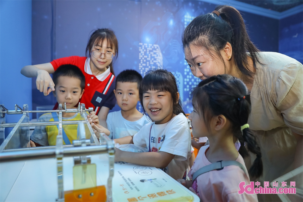 <br/>Children are seen experiencing the fun of scientific experiments through hands-on activities such as hand-eye coordination, dancing paper clips, and sound standing waves at a Science Popularization Museum in Qingdao City, Shandong Province. (Photo by Zhang Ying)<br/>